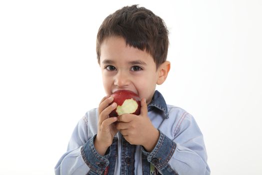 Child eating an apple on white background