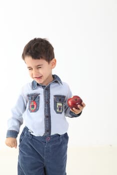 Child dislike eating an apple on white background