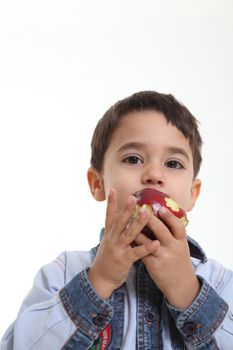 Child eating an apple on white background