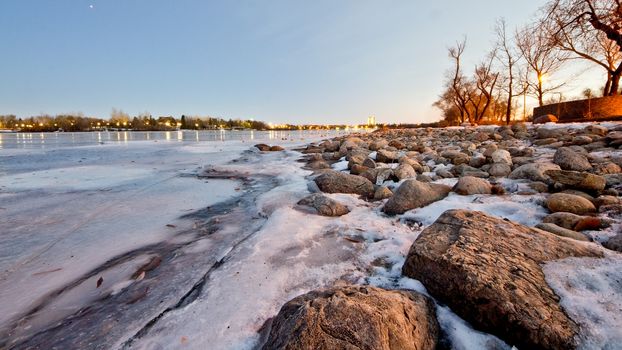 Wascana lake in Regina, Saskatchewan beginning to freeze during the cold winter days in November