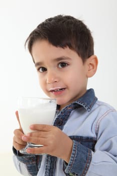 Handsome child drinking a glass of milk