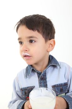 Handsome child drinking a glass of milk