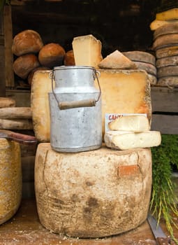 old milk jug and cheese, presented in a market in France