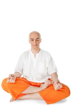 Male sitting in lotus position practicing yoga meditating, isolated on white