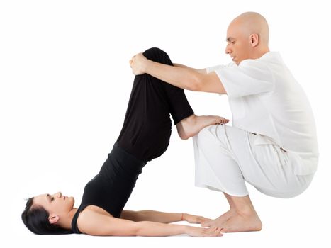 Young woman being stretched in thai position by therapist