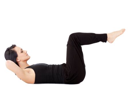 Young woman doing abdominal exercise with raised legs, isolated on white