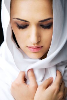 Portrait of a beautiful woman wearing white veil over head, eyes closed