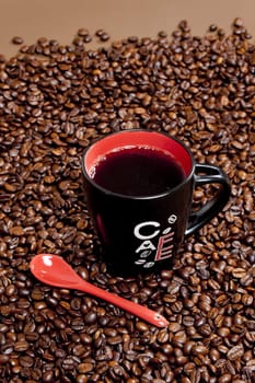 cup of coffee with coffee beans