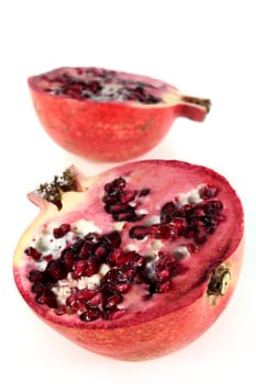 a sliced pomegranate on a white background