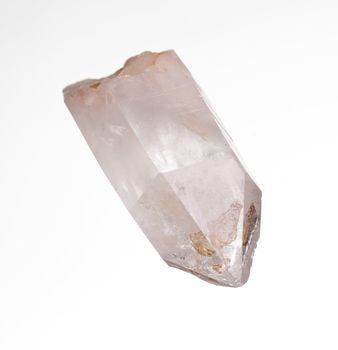 Lights illuminate a shaped quartz crystal showing the facets and marks