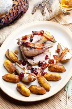 baked pheasant with bacon, pear, raisins on brandy