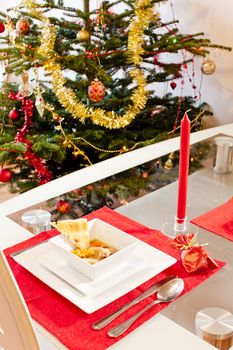 Christmas tree and Christmas fish soup on table