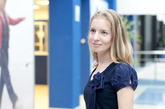 Portrait of the young woman in shopping center