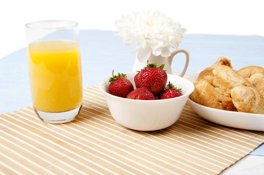 light Breakfast: orange juice, croissants and Berries on a table