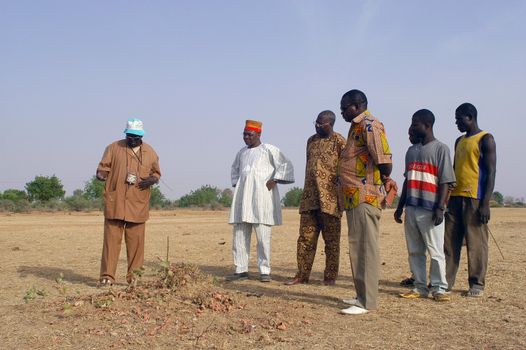 African waterfinder with work in an area of Burkina Faso Faso. Water is not rare in Africa, only it is necessary to drill wells to reach it. The waterfinder thus determines the place exact where to drill because drilling costs 8000 ? and it is not question of missing the place where the machines will have to work.