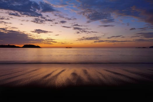 Purple skies and flowing water at sunset in Guanacaste