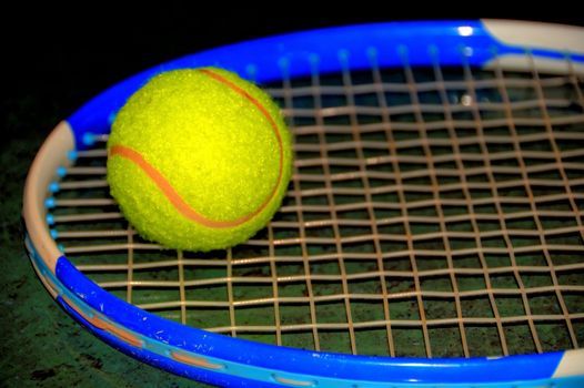 tennis ball and racket on green background