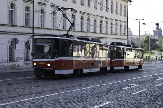 A public rail car in driving through the streets of Prague
