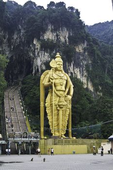 The large gold hindu statue in front of Batu caves in Malaysia.