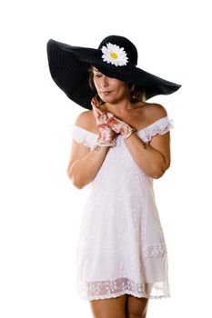 Studio portrait of attractive woman in a large black hat isolated on white