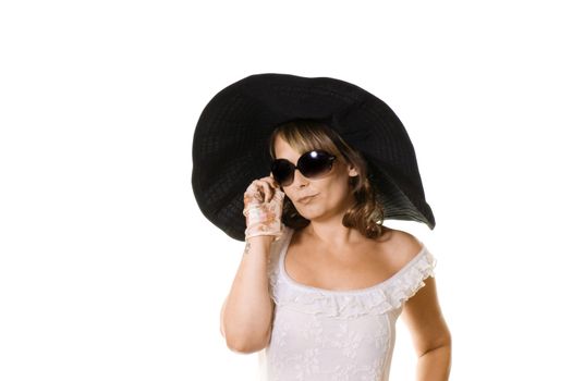 Studio portrait of attractive woman in a large black hat isolated on white