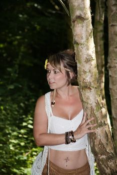 outdoor portrait of a woman dressed in hippie fashion in a woodland setting