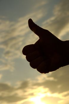 hand against sunset