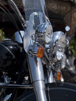 Chrome headlights of classic American motorcycle. Shallow depth of field.