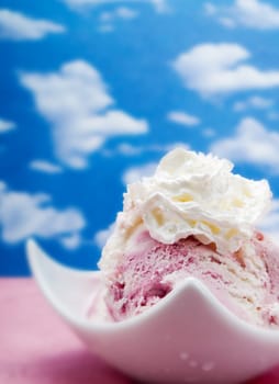 Pink ice cream on a blue sky