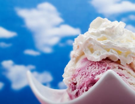 Pink ice cream on a blue sky