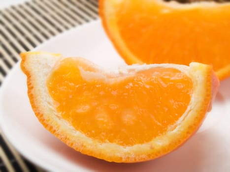 Orange slice on  a white plate