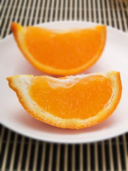 Orange slice on  a white plate