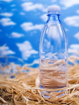 Bottle of mineral water over a blue sky