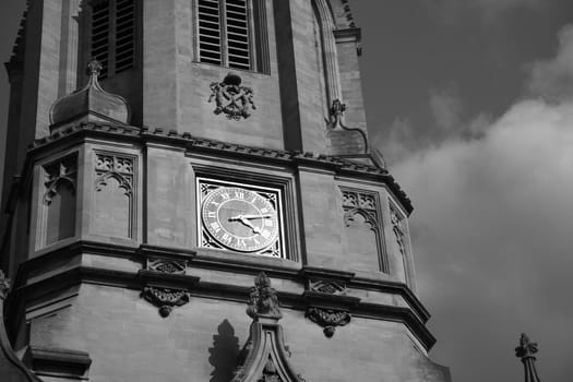 Black and white image of the main tower of Christ Church, Oxford, UK, named after the bell "Old Tom" it hauses. Christ Church is one of the colleges of Oxford Univeristy and at the same time the Cathedral church of the diocese of Oxford.