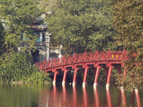 Bridge to an island with a small temple at one of the lakes in Hanoi, Vietnam.