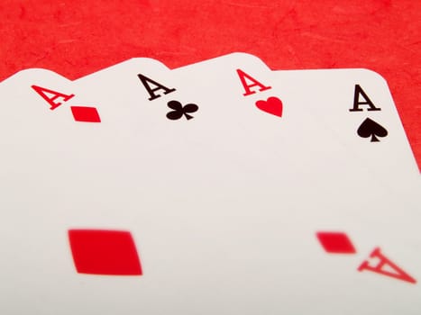 Four aces cards on a red background