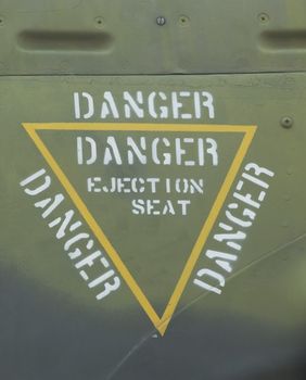 Warning sign on a military airplane with the text: DANGER EJECTION SEAT