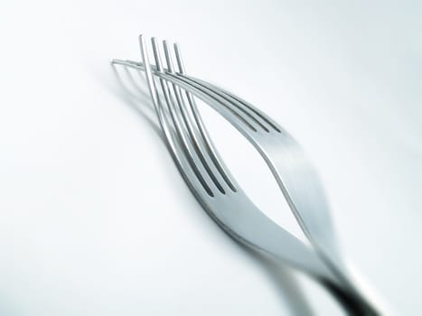 Two forks on a white background