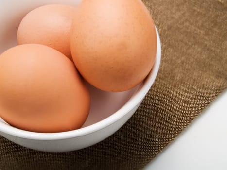 Three eggs in a white bowl