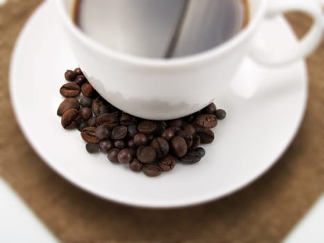 Coffee beans on a cup of coffee