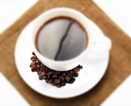 Coffee beans on a cup of coffee