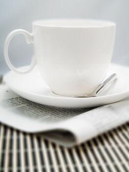 Coffee cup and newspaper