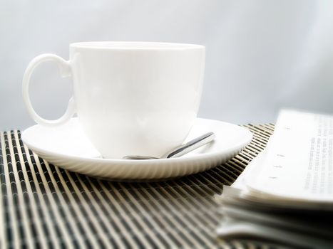 Coffee cup and newspaper