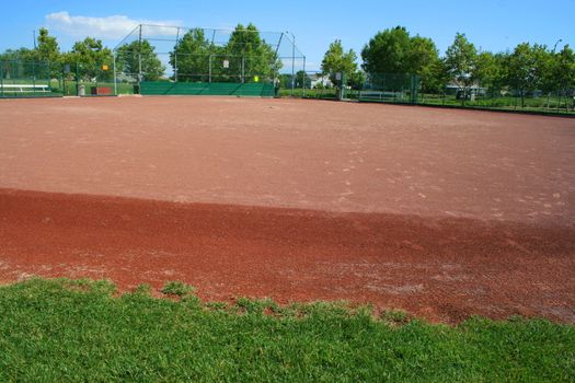 Empty baseball field on a sunny day.
