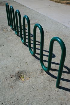 Close up of a green bike rack.
