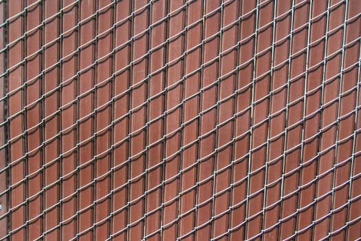 Close up of a chain link fence showing unique pattern.