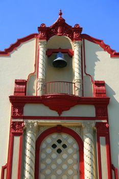 Tall classic style church in a city.
