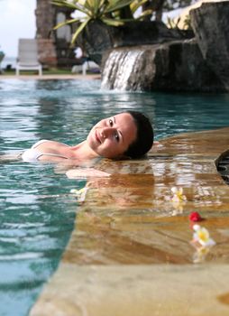 Beautiful woman enjoying summer in the pool