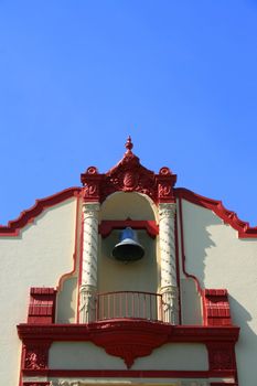 Tall classic style church in a city.
