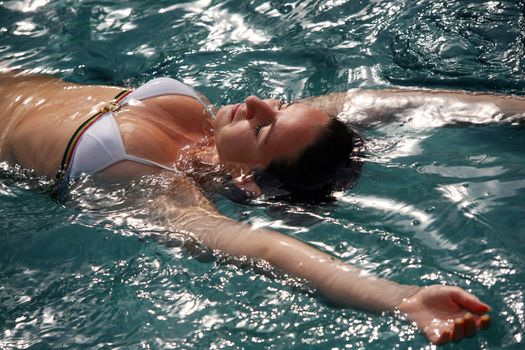 Beautiful woman enjoying summer in the pool